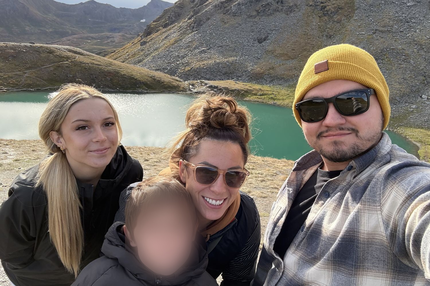 Carlos Soto with his wife Joanna and their two children beside an alpine lake in the mountains of Southern Utah