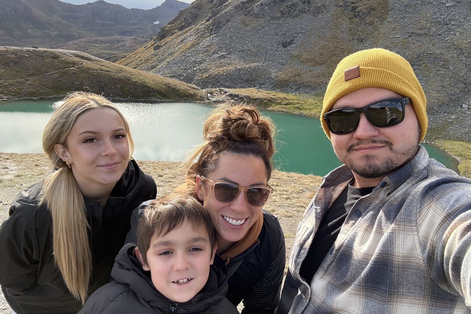 Carlos Soto with his wife Joanna and their two children beside an alpine lake in the mountains of Southern Utah